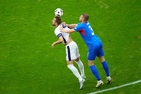 Harry Kane is pushed by Slovakia's Denis Vavro